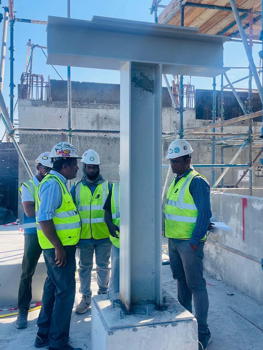 Site supervisors inspecting a structural steel beam on site